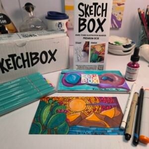 SketchBox professional markers displayed with completed desert and neurographic artwork on an artist’s desk.