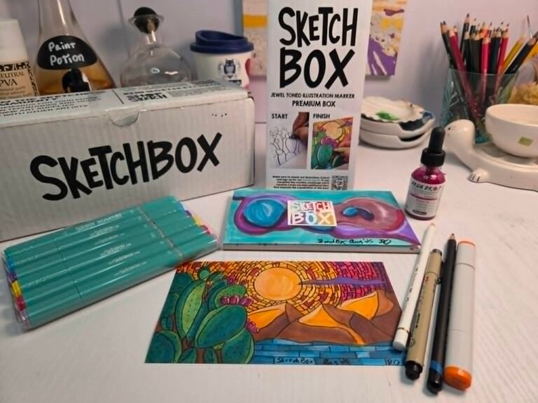 SketchBox professional markers displayed with completed desert and neurographic artwork on an artist’s desk.